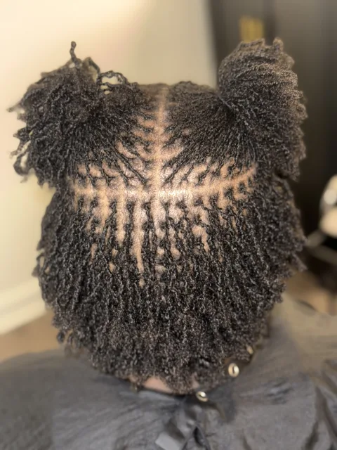 Back view of short fine locs and carefully sectioned roots at September’s Locs