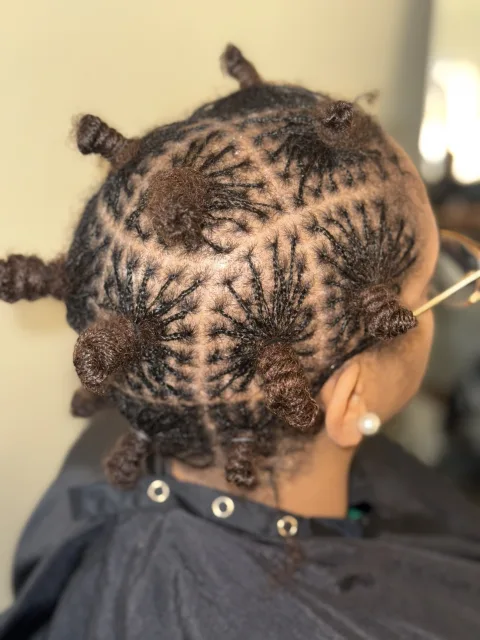 Side view of locs styled into small knots at September’s Locs