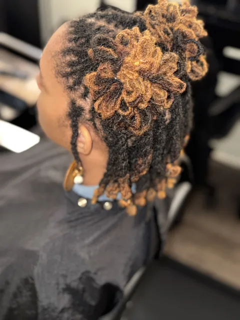 Golden-tipped locs gathered into a high style at September’s Locs